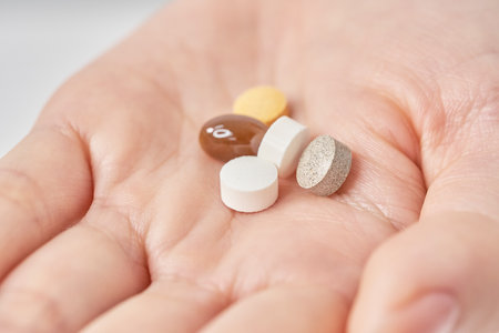 Various pills on the hand and white backgroundの写真素材