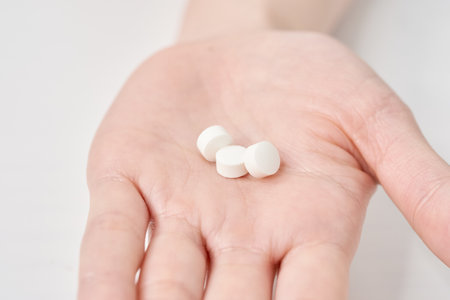 Various pills on the hand and white backgroundの写真素材