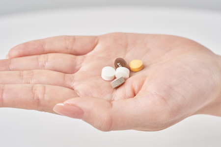 Various pills on the hand and white backgroundの写真素材