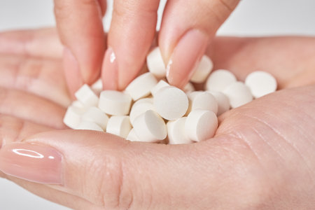 many pills in the palm and white backgroundの写真素材
