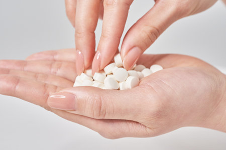 many pills in the palm and white backgroundの写真素材