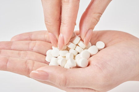 many pills in the palm and white backgroundの写真素材