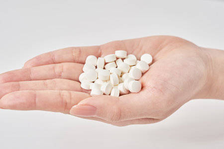 many pills in the palm and white backgroundの写真素材
