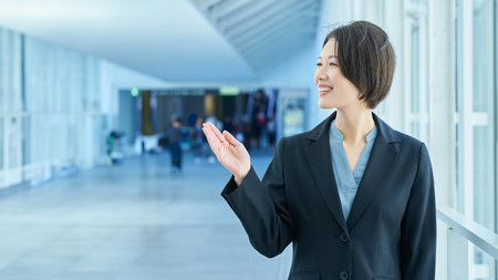 Business woman posing in rejection in the aisleの写真素材