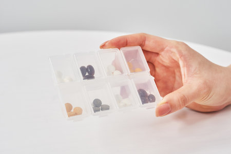 Tablets in individually separated plastic cases and white backgroundの写真素材
