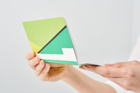 Woman's hand looking at bank passbook and white backgroundの写真素材