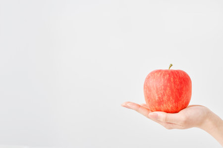 apple in the palm of your hand and white backgroundの写真素材