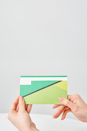 Woman's hand looking at bank passbook and white backgroundの写真素材