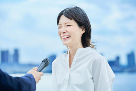 Young woman being interviewed in the cityの写真素材
