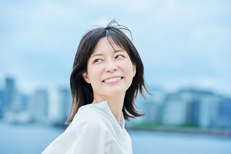 portrait of young woman outdoors and the cityの写真素材