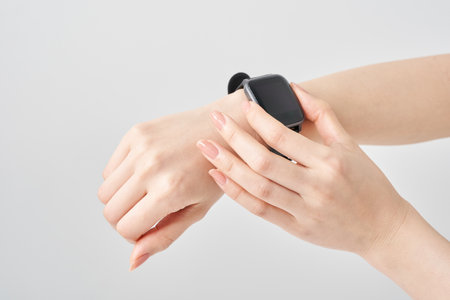 smart watch on a woman's wrist and white backgroundの写真素材