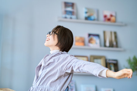 middle aged woman relaxing in the roomの写真素材