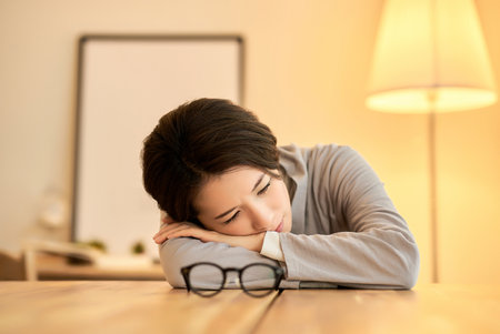 Middle-aged woman taking a break in her roomの写真素材