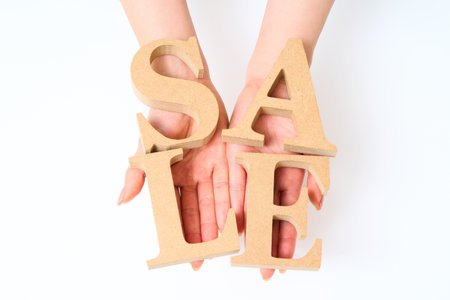 Wooden alphabet blocks with the word "SALE" and White backgroundの写真素材