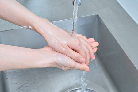 Beautiful hands of a woman washing her hands
