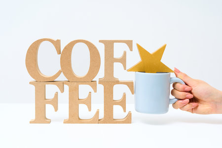 Wooden alphabet blocks arranged with the word COFFEE and white background