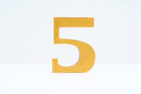 Wooden block with the number "5" and white backgroundの写真素材