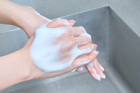 Beautiful hands of a woman washing her hands