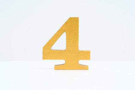 Wooden block with the number 4 and white background