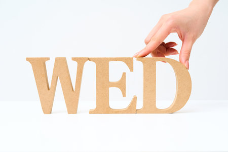 Wooden alphabet blocks arranged to spell out "WED" and white backgroundの写真素材