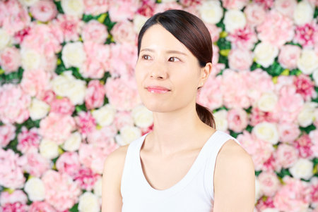 Woman wearing a tank top and white backgroundの写真素材