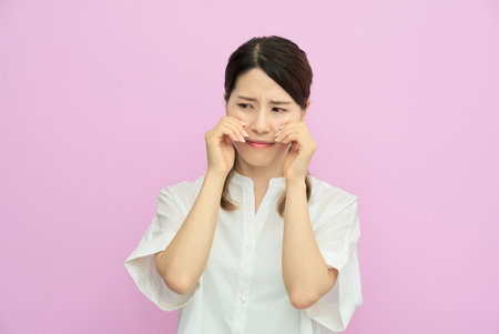 Portrait of a crying young womanの写真素材