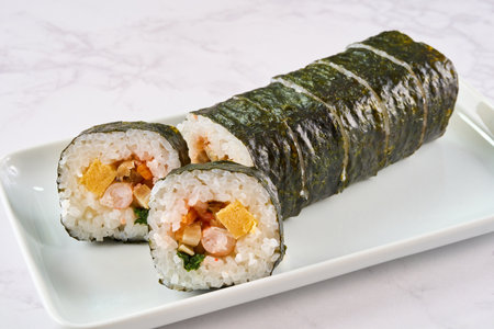 Sliced â€‹â€‹â€‹â€‹sushi rolls on a plate