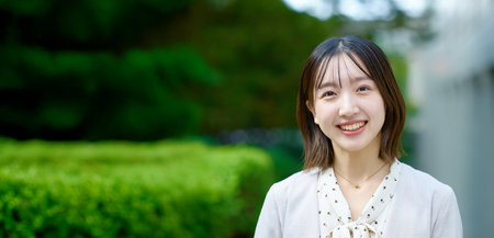 Smiling young business woman outdoors on fine dayの写真素材