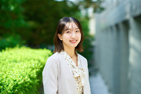 Smiling young business woman outdoors on fine dayの写真素材