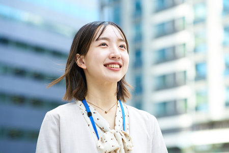 Smiling young business woman outdoors on fine dayの写真素材