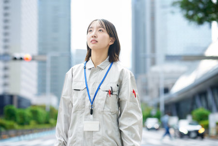 Young woman in work clothes outdoorsの写真素材