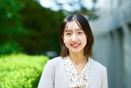Smiling young business woman outdoors on fine dayの写真素材