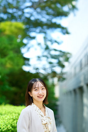Smiling young business woman outdoors on fine dayの写真素材