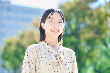 Portrait of a young woman relaxing in green spaceの写真素材
