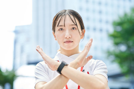 A young nurse posing in refusal outdoorsの写真素材