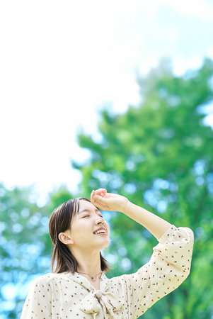 Portrait of a young woman relaxing in green spaceの写真素材
