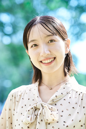 Portrait of a young woman relaxing in green spaceの写真素材