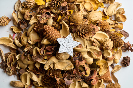 Star-shaped decoration amongst fallen leaves on the tableの写真素材