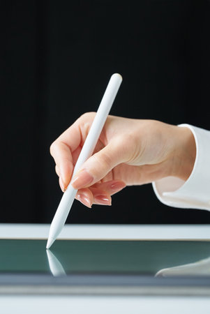 Hand holding a stylus pen on studioの写真素材