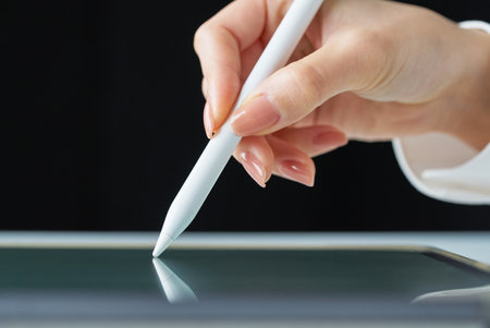 Hand holding a stylus pen on studioの写真素材