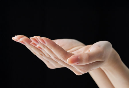Scooping up with the palm of your hand and black backgroundの写真素材