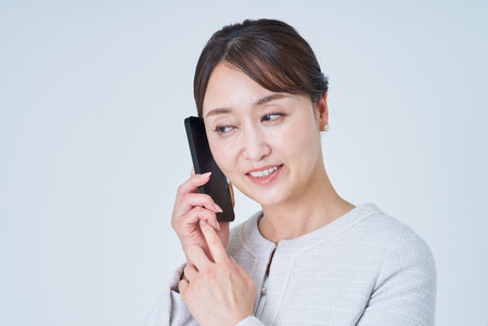 Business woman talking on a smartphoneの写真素材