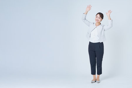 Business woman posing to cheer and white backgroundの写真素材