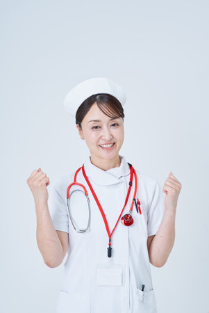 A female medical staff member posing for support and white backgroundの写真素材