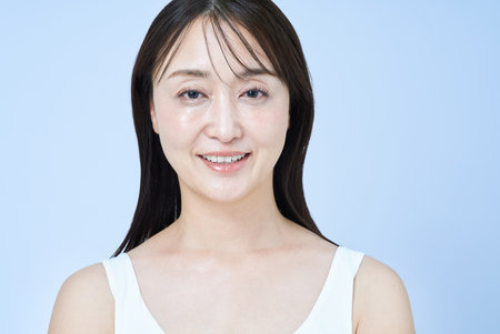 portrait of a middle aged woman and white backgroundの写真素材