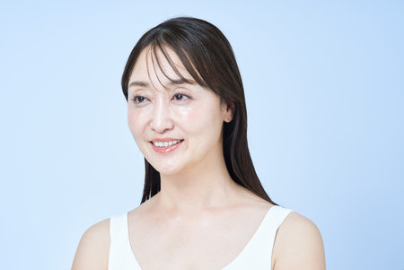 portrait of a middle aged woman and white backgroundの写真素材