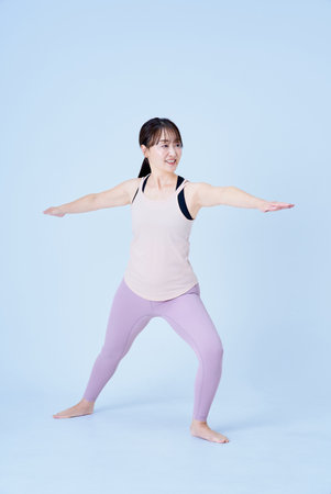 Asian woman doing yoga pose and white backgroundの写真素材