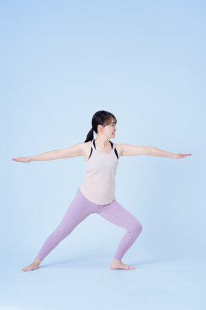 Asian woman doing yoga pose and white backgroundの写真素材