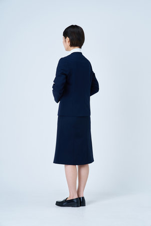 Young woman in a suit and white backgroundの写真素材