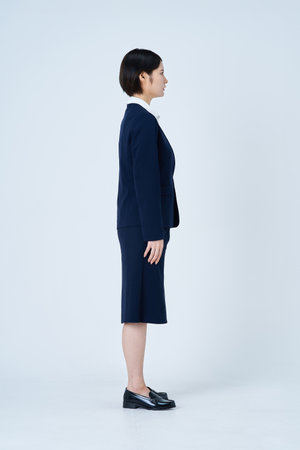 Young woman in a suit and white backgroundの写真素材